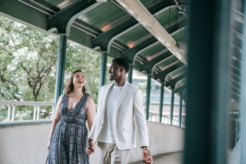 Diverse couple walking outdoors, symbolizing connection and vitality