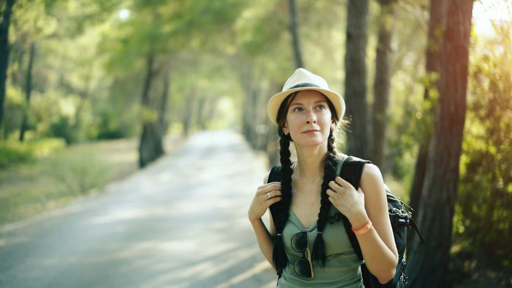 Woman journaling outdoors in nature, representing healing and functional wellness